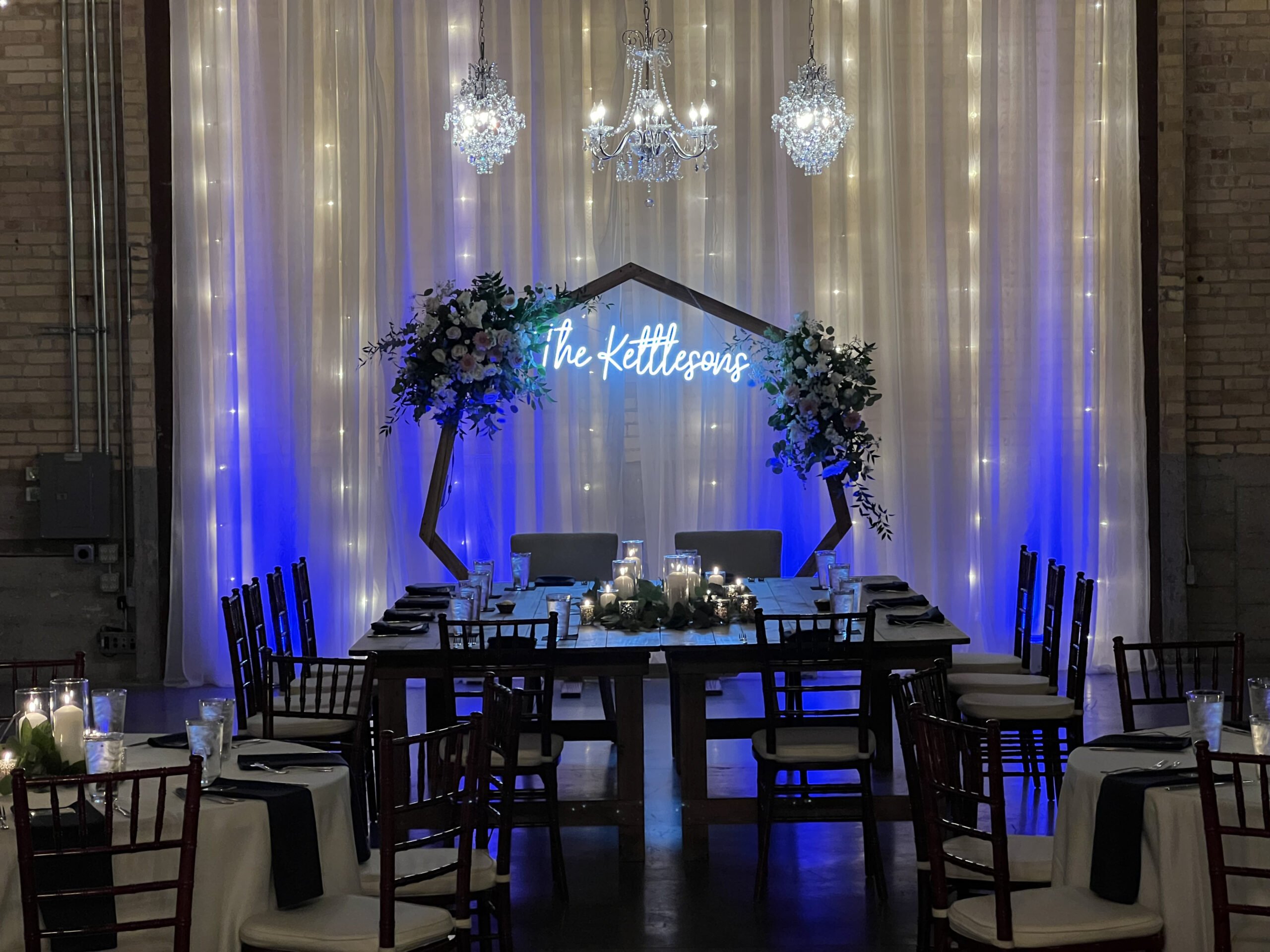 Queens Table for a wedding at Gather on Broadway with a neon sign backdrop